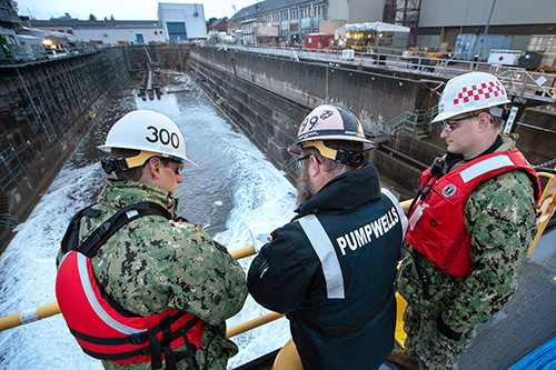 three engineers review the Bremerton shipyard site